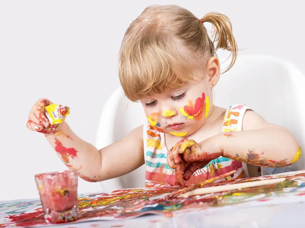 Children expressing creativity through finger painting and sensory art activities