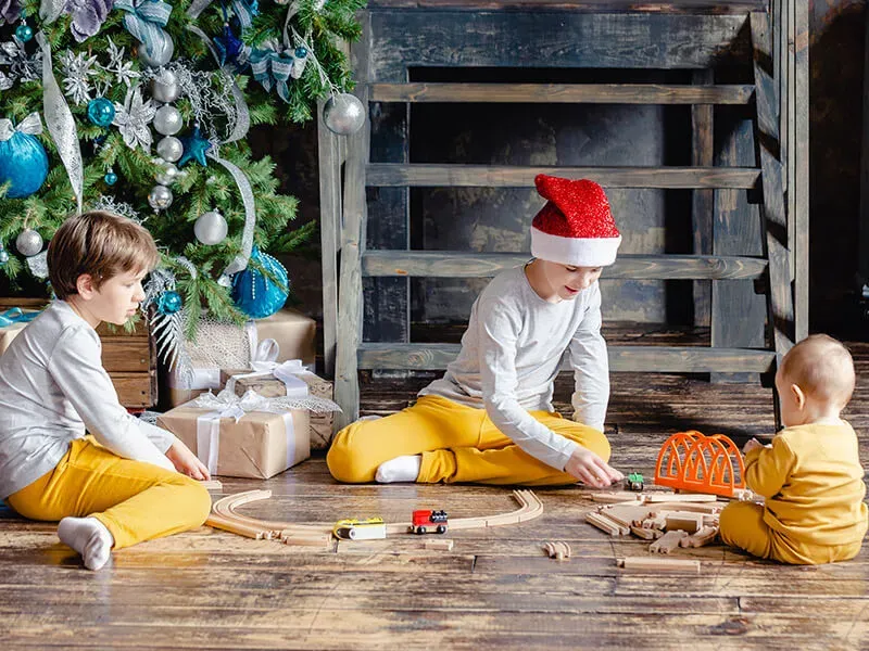 Parent comforting child during holiday daycare drop-off
