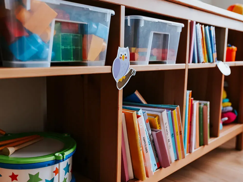 Organized daycare book baskets with labeled bins for easy transport