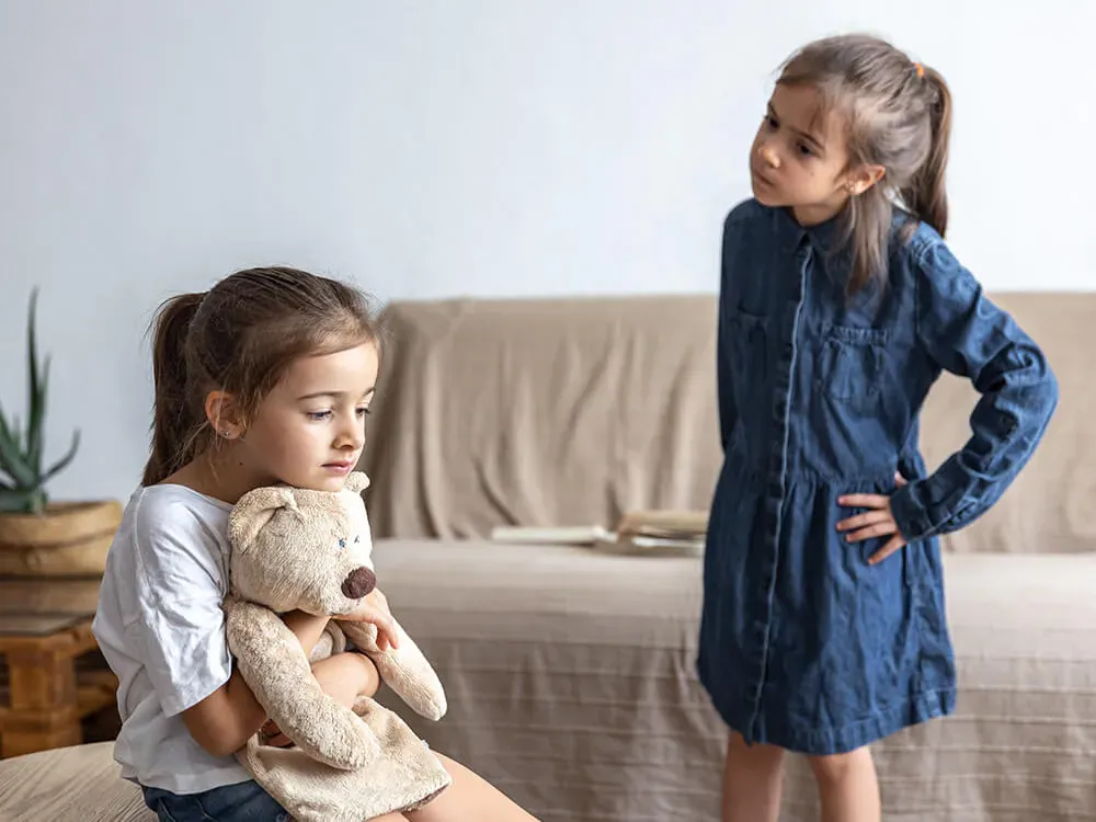 Parent comforting a child and teaching them about social mistakes